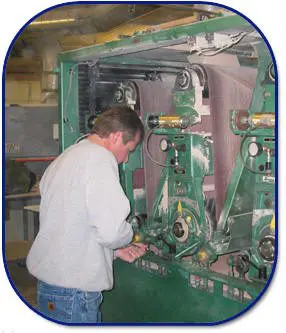 A man working on machinery in an industrial setting.