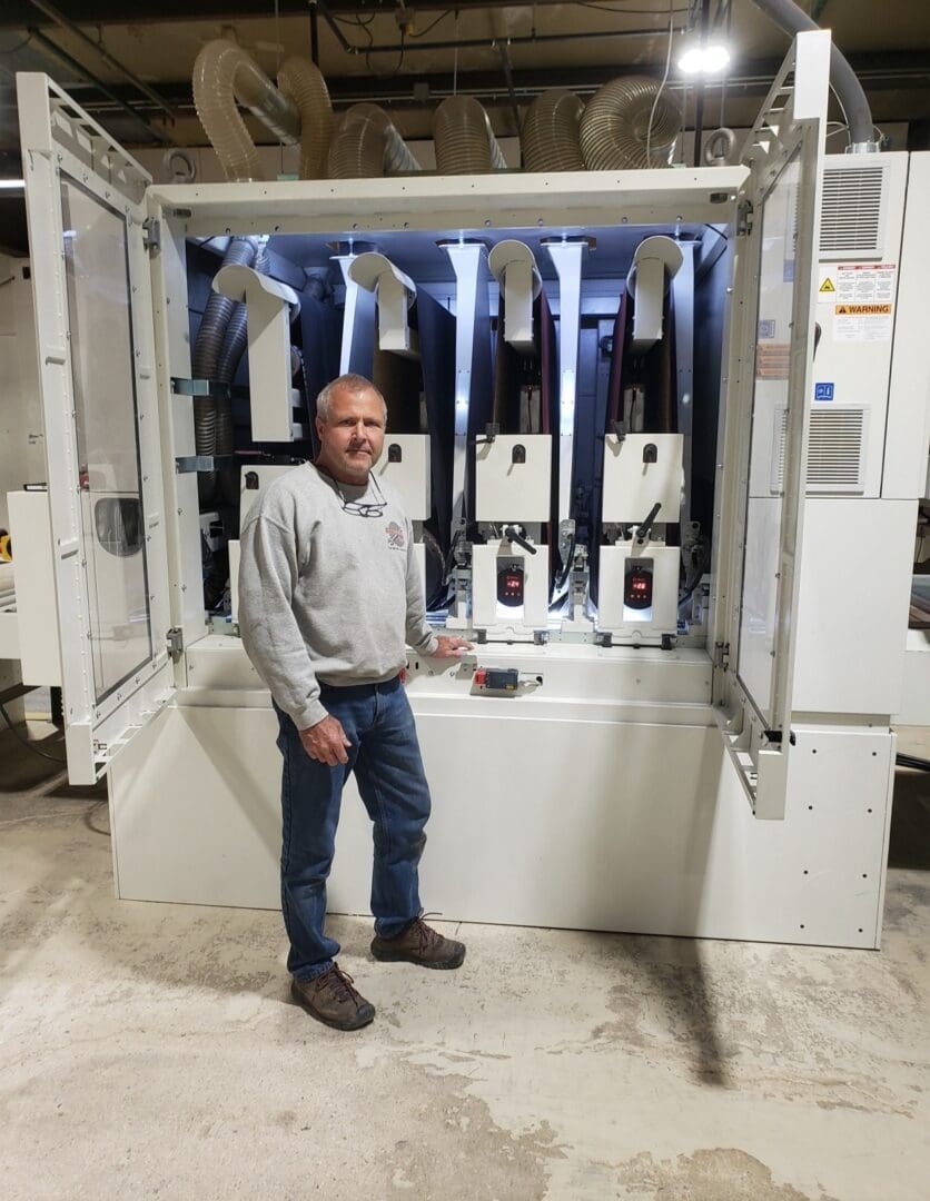 A man standing in front of an electrical cabinet.